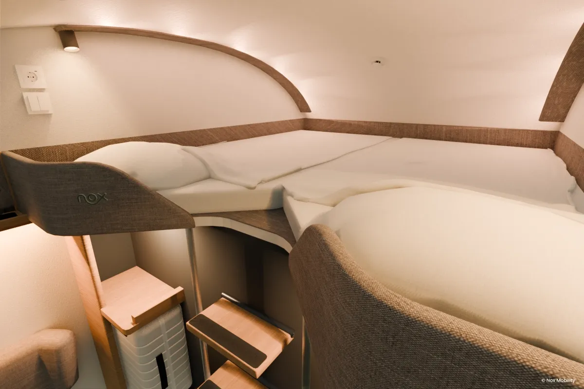 A stylish night train room for two people with a double upper bed